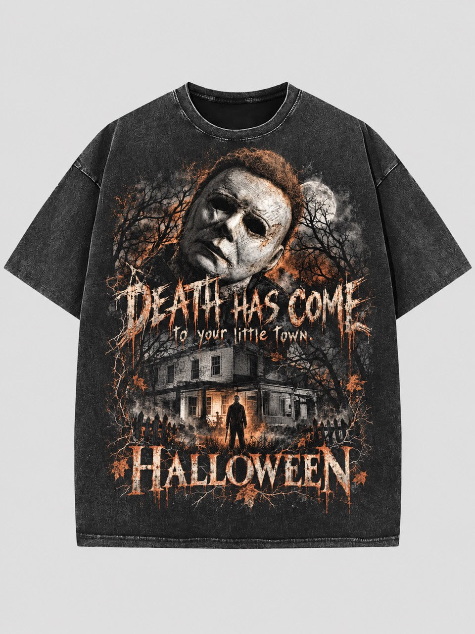 Washed dark T-shirt with a Michael Myers portrait, moonlit house, orange accents, and “Death Has Come to Your Little Town” lettering.